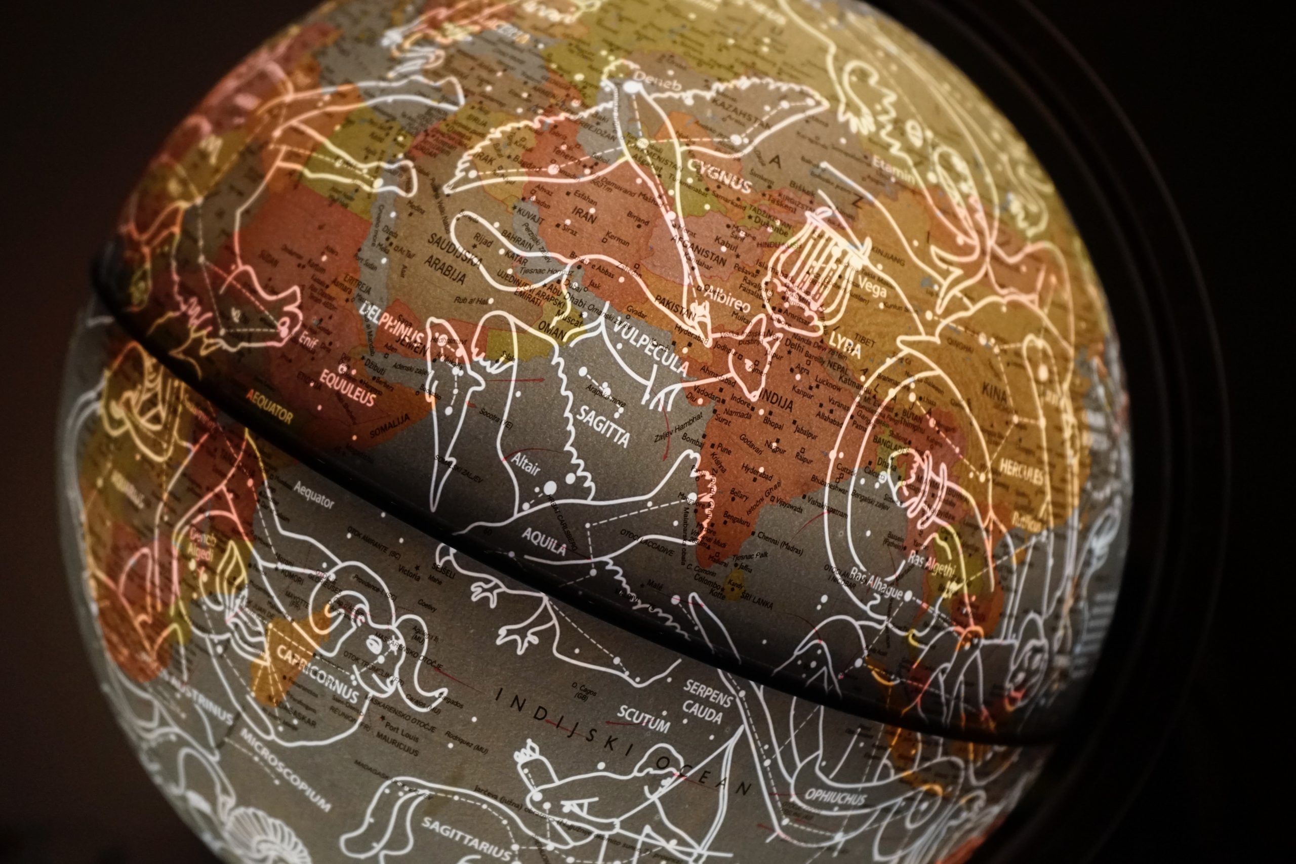 neon constellations on lit globe