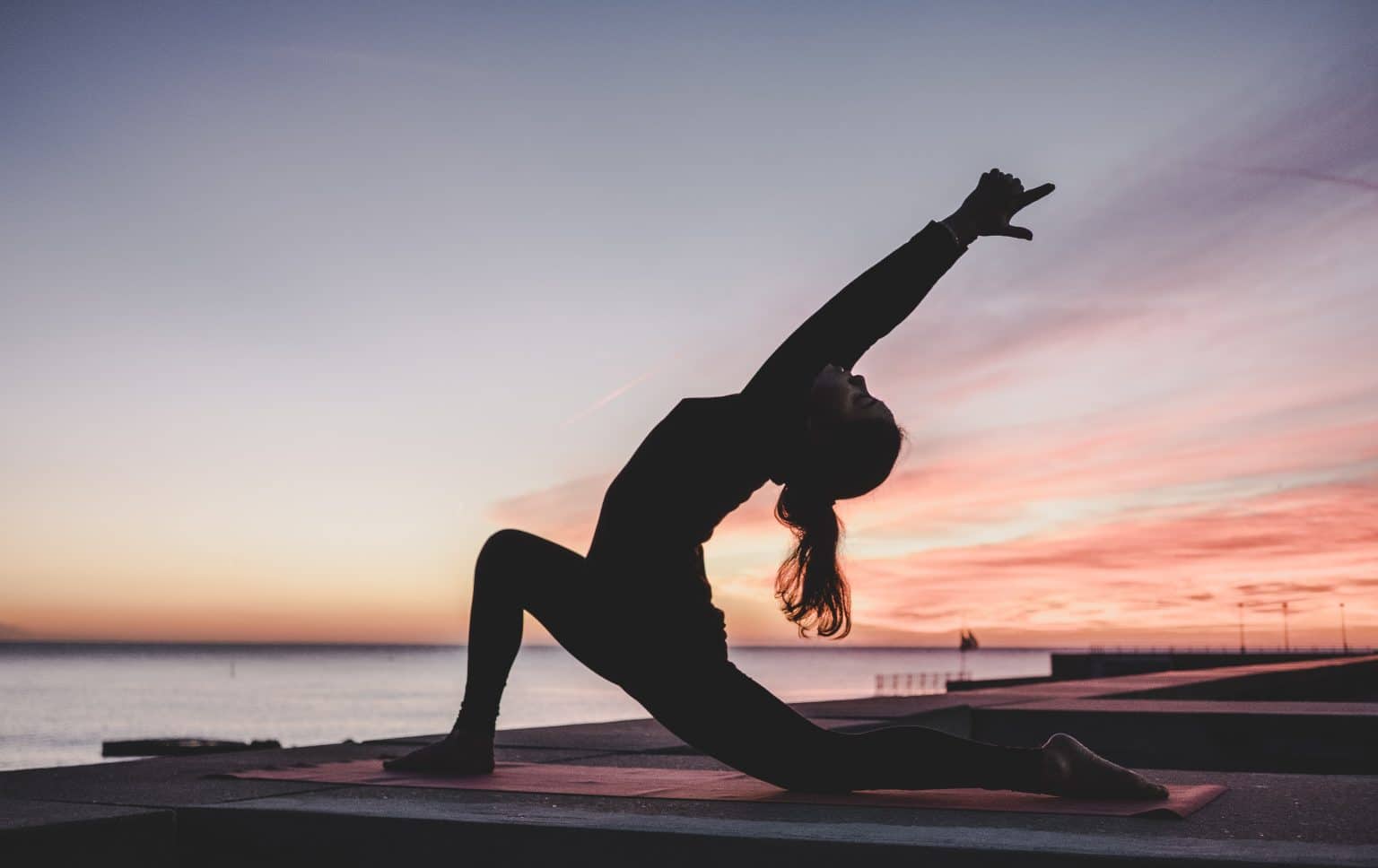 outdoor yoga low lunge asana at sunset