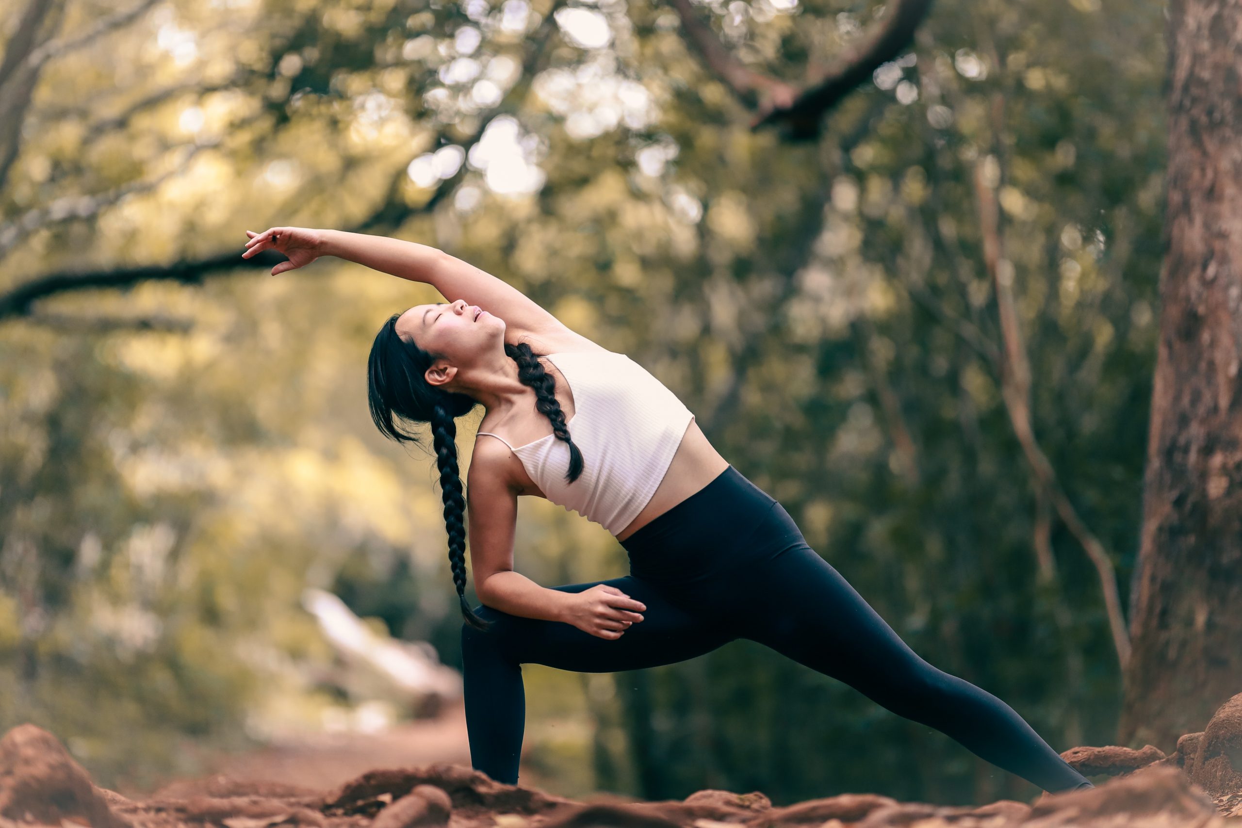 outdoor yoga in woods warrior II