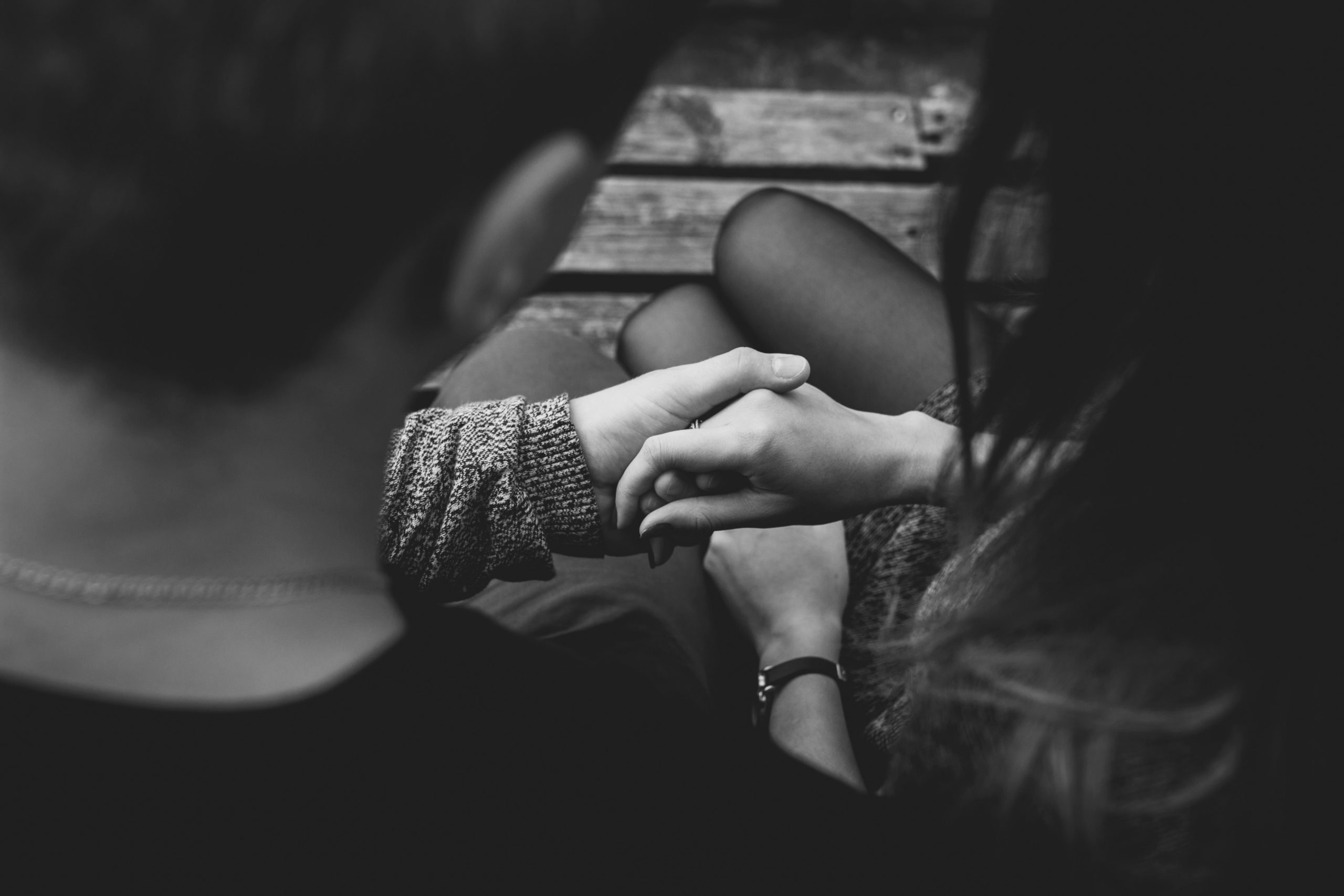 couple holding hands black white