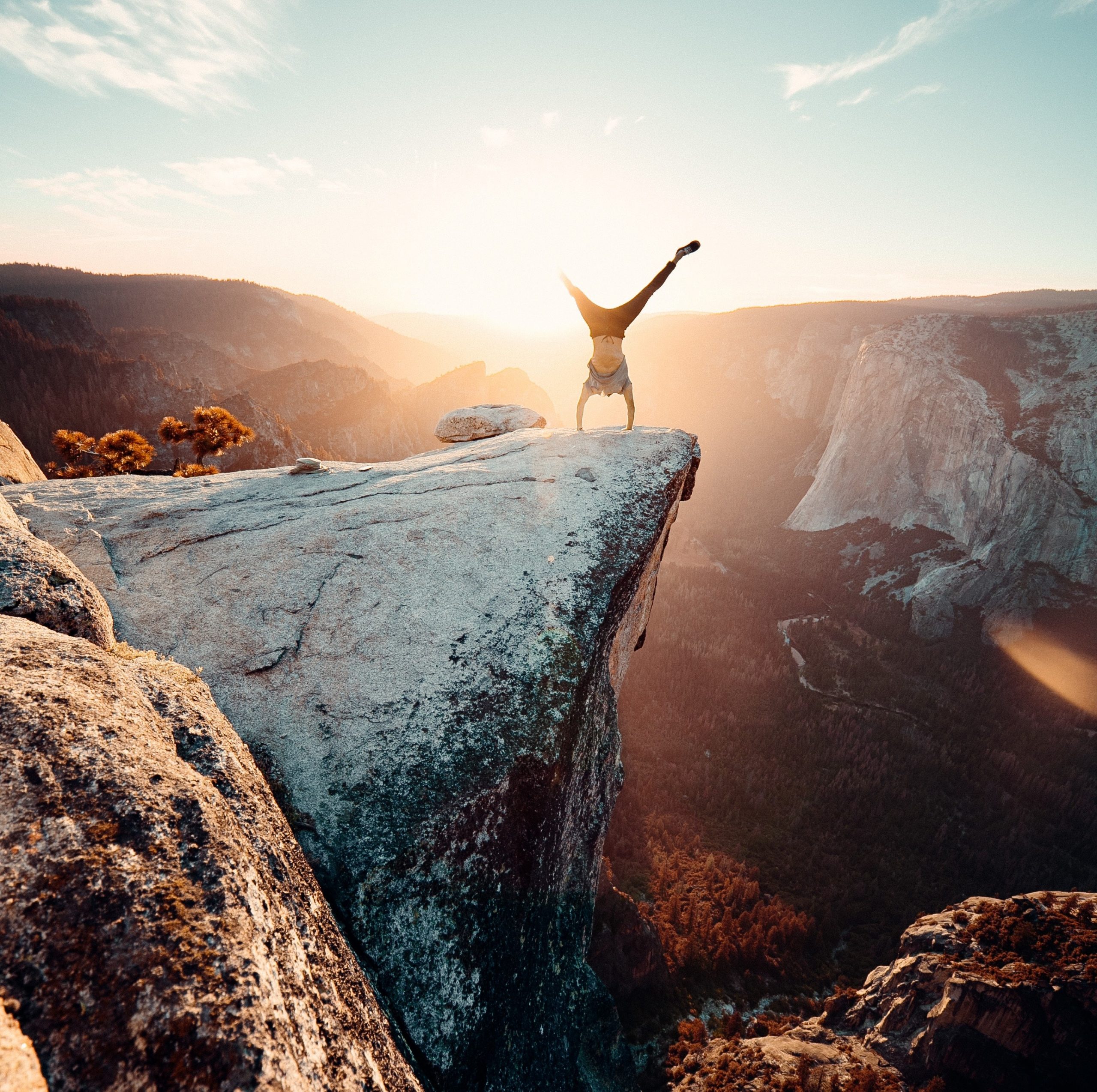 handstand in sun on cliff