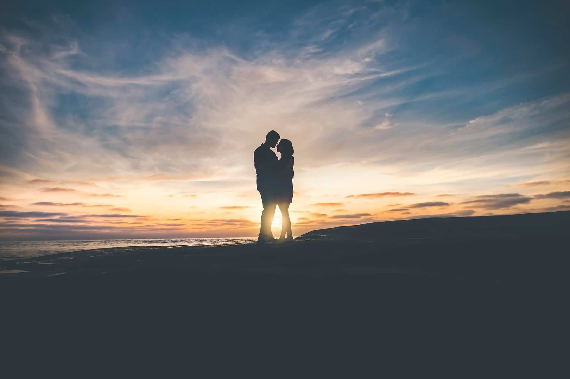 silhouette couple on beach at sunset