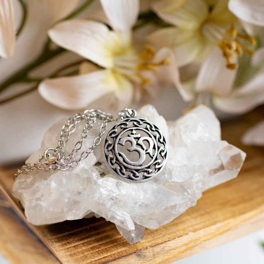 ohm symbol pendant silver on rock crystal
