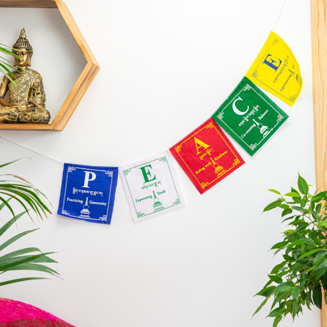 gold meditating buddha statue altar, tibetan prayer flags peace
