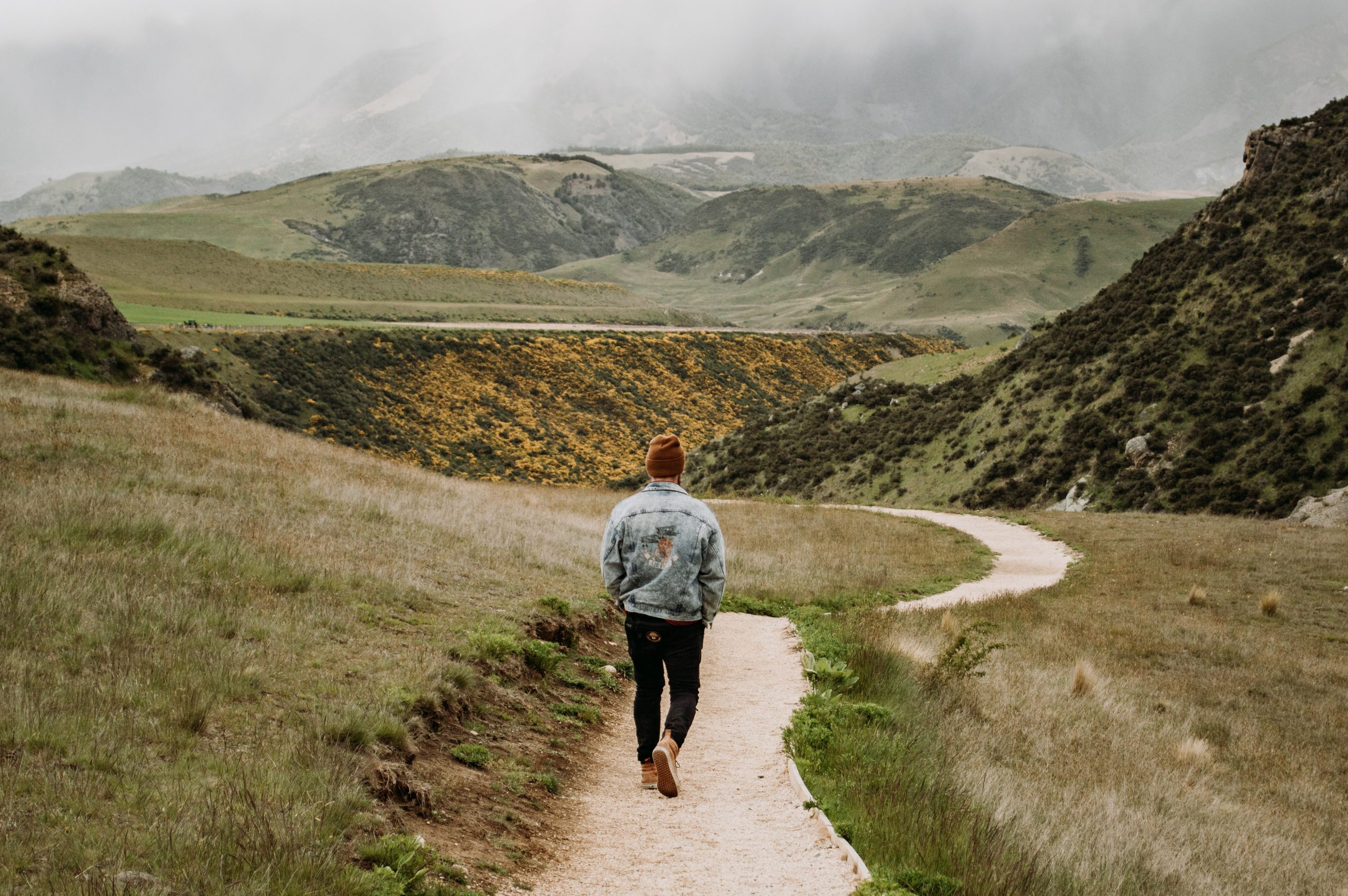 man walking in the hills