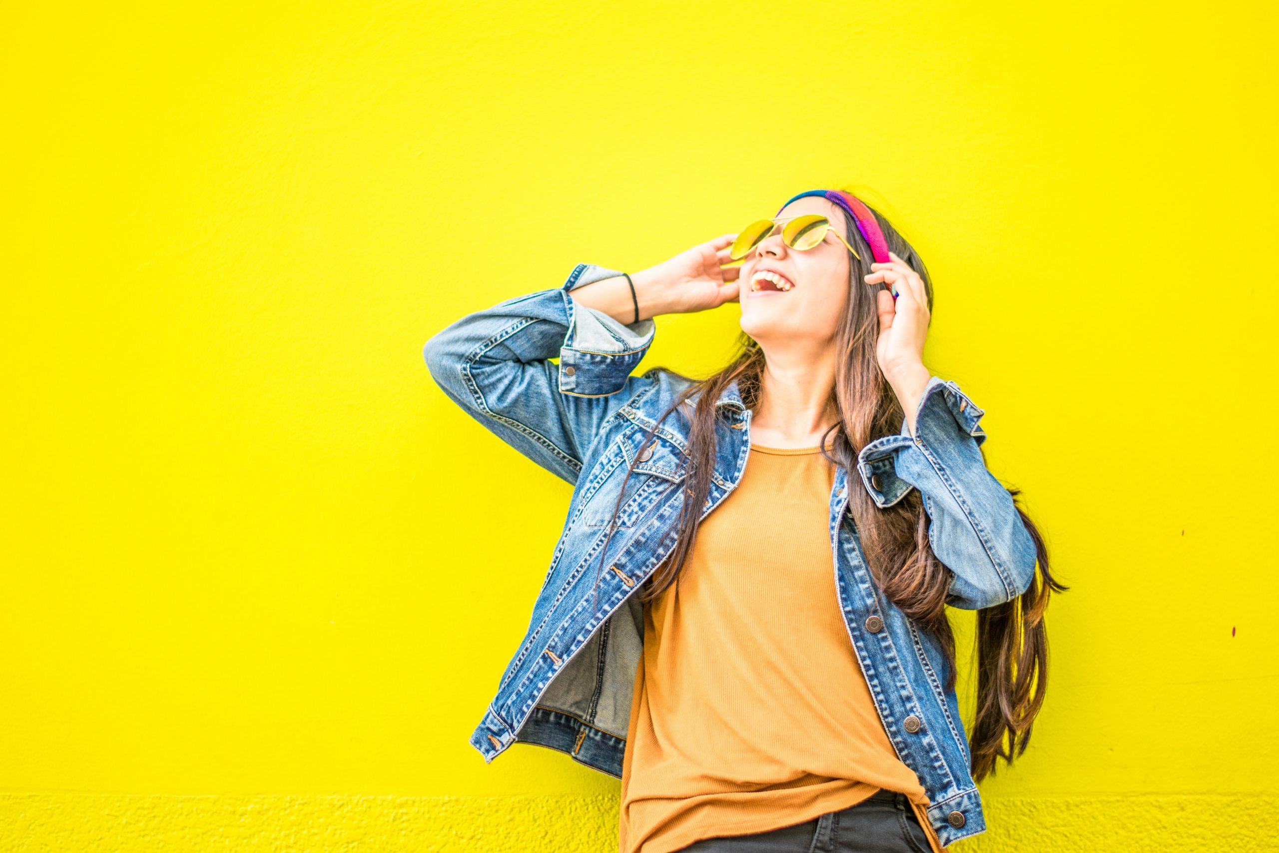 happy woman in yellow with sunglasses