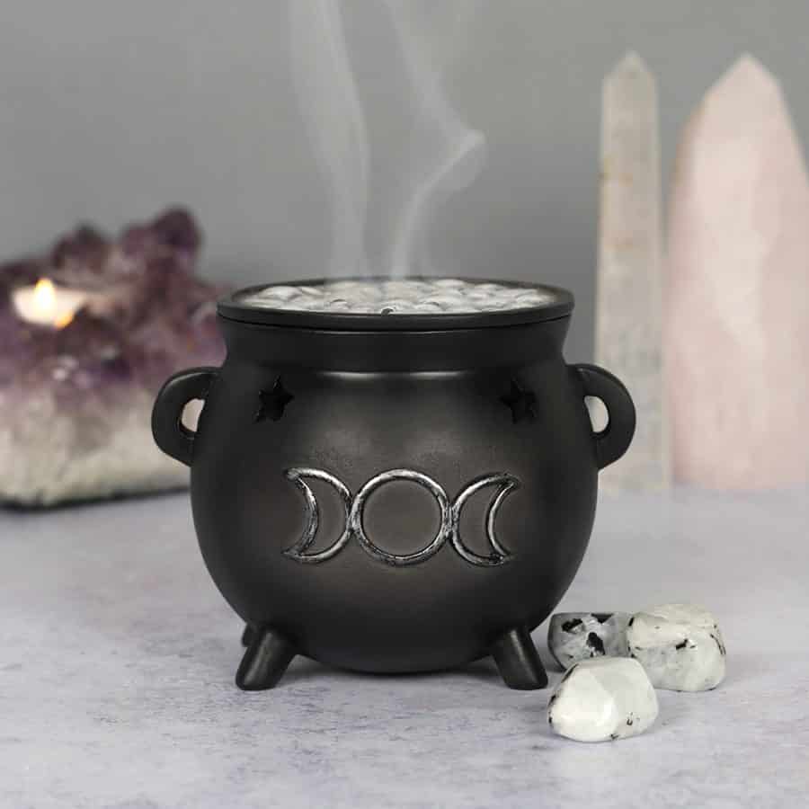 moon phases witches cauldron with crystals amethyst rock crystal rose quartz golden triangle