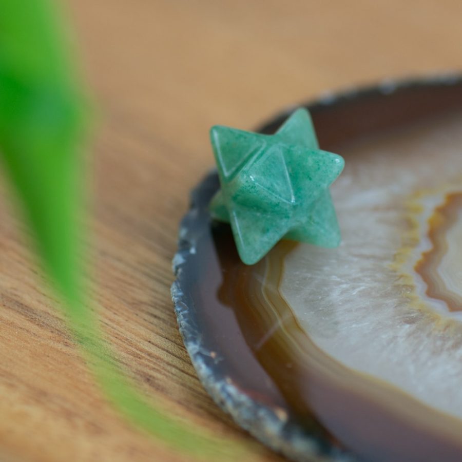 green aventurine merkaba on agate slice polished