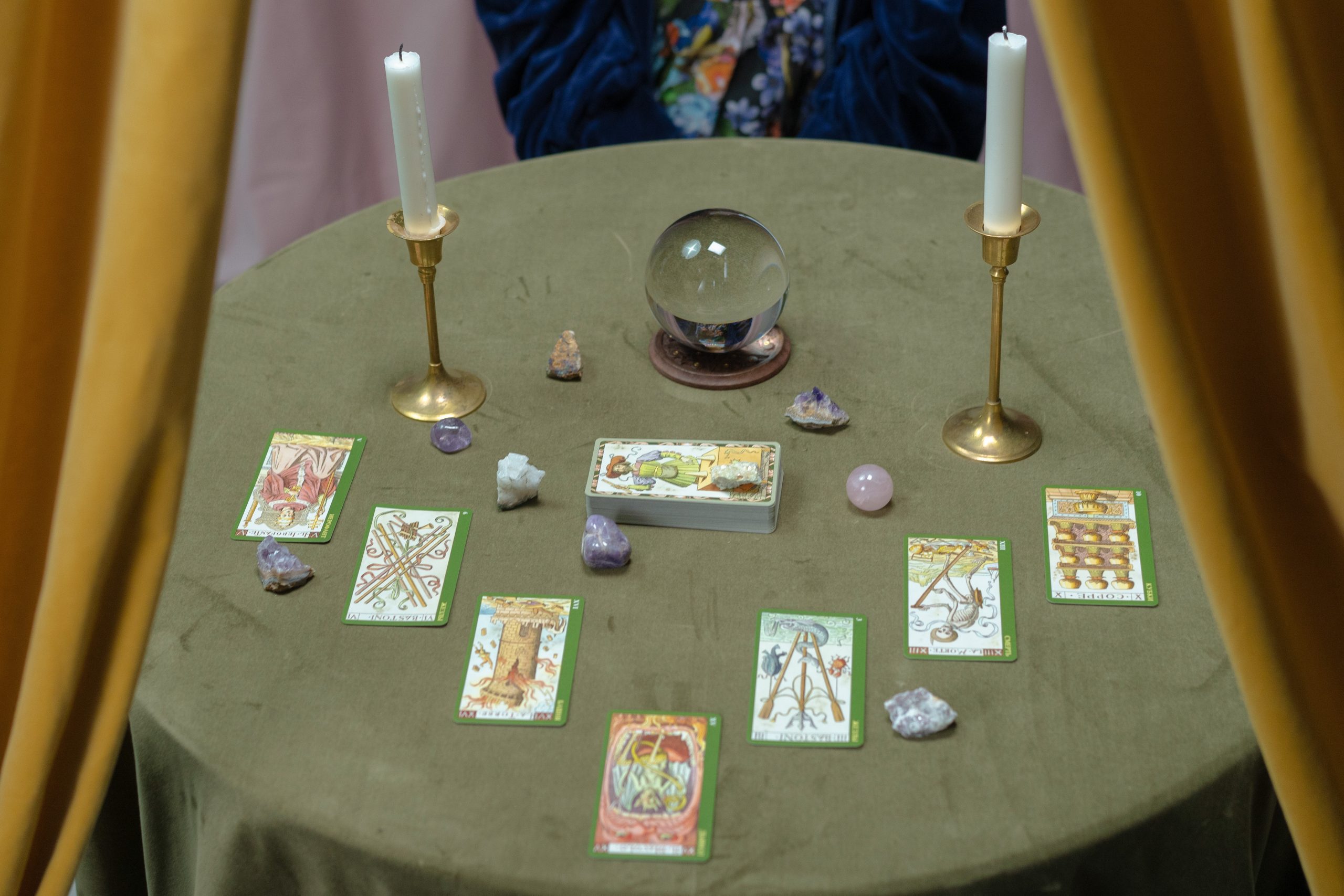 crystal ball gypsy fortune teller table tarot cards white candles