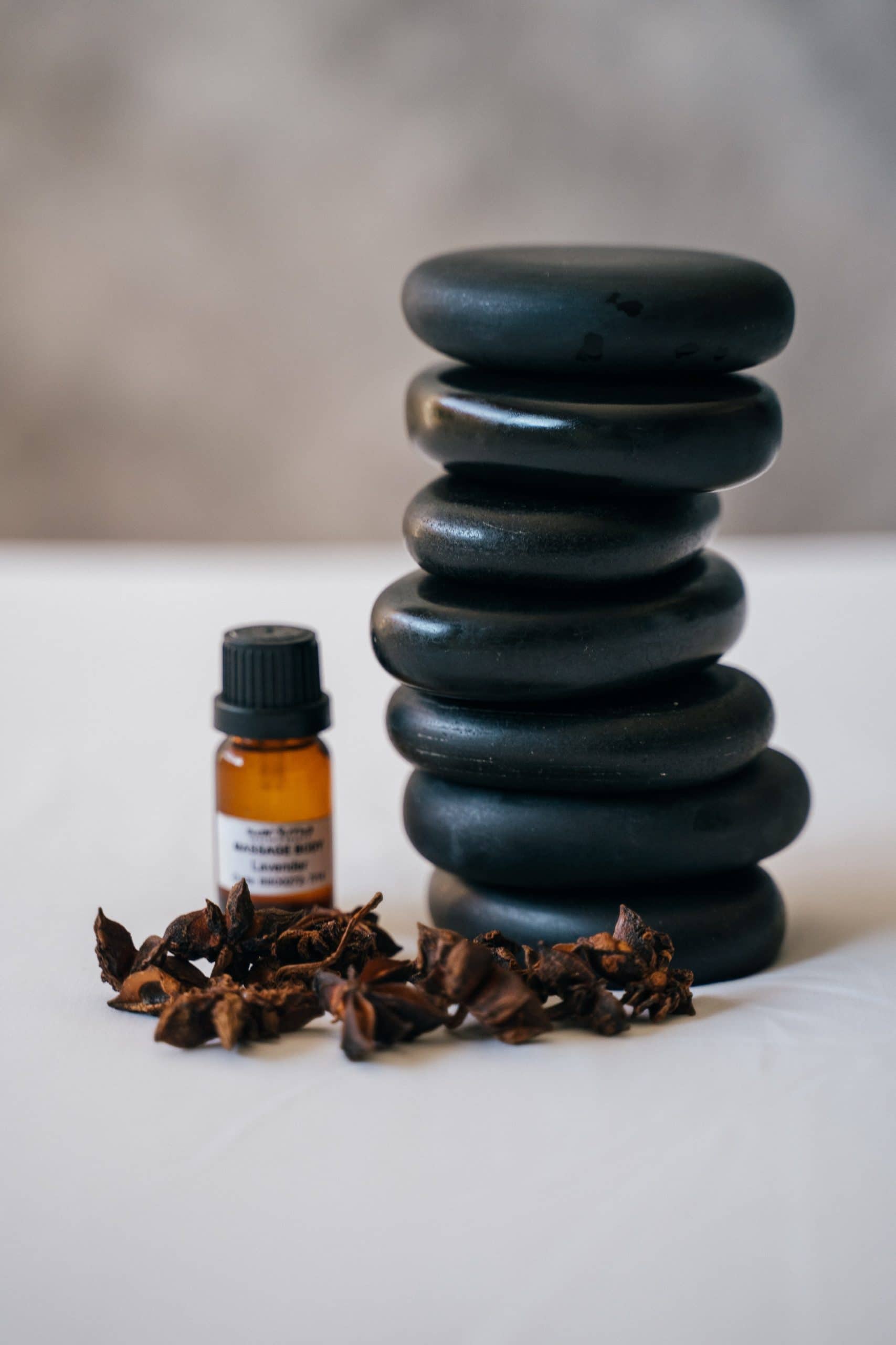 black basalt massage stones with clove massage oil and cloves